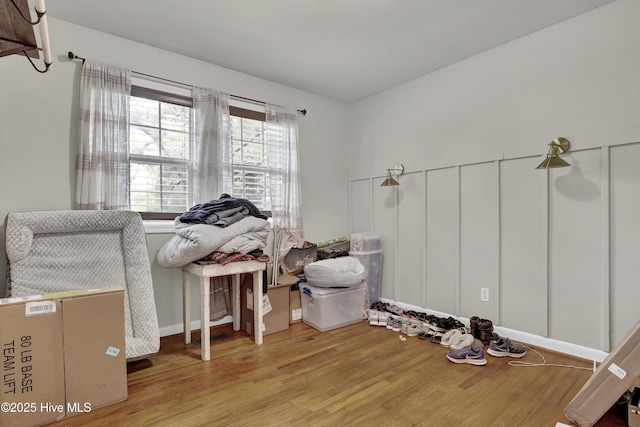 interior space with wood finished floors and baseboards