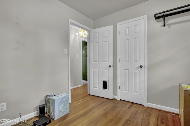 unfurnished bedroom with wood finished floors and baseboards