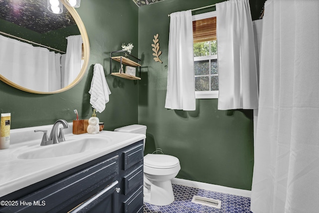 bathroom with tile patterned floors, toilet, vanity, baseboards, and visible vents