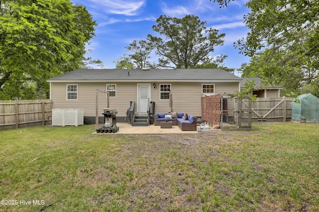 rear view of property featuring an outdoor living space, a fenced backyard, entry steps, a patio area, and a lawn