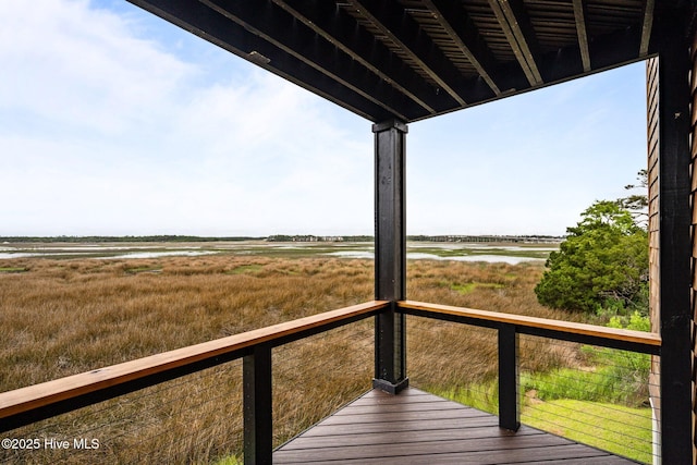 wooden terrace featuring a water view