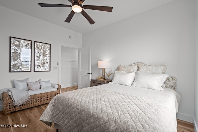 bedroom featuring baseboards, ceiling fan, and wood finished floors