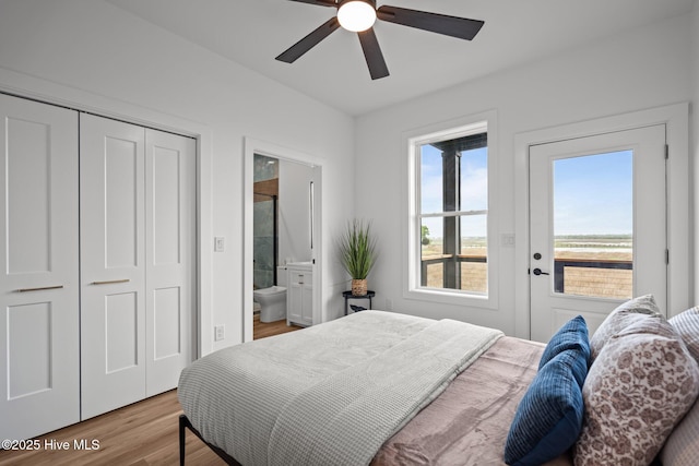 bedroom with a closet, ensuite bath, wood finished floors, and a ceiling fan