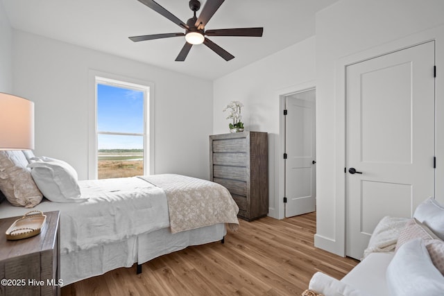 bedroom with a ceiling fan and light wood-style floors