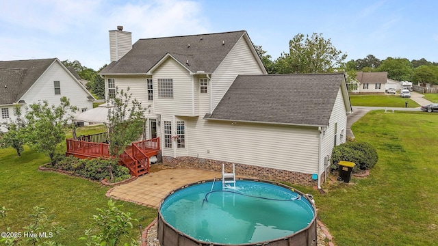 1114 Stone Creek Dr, Greenville, NC 27858 - rear view of property with a wooden deck, a shingled roof, a yard, a chimney, and an outdoor pool