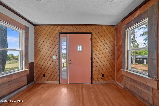 9952 US Highway 17 S, Vanceboro, NC 28586 - entrance foyer with a textured ceiling, baseboards, wood walls, and light wood-style floors