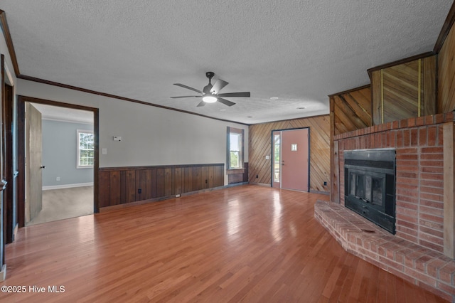 9952 US Highway 17 S, Vanceboro, NC 28586 - unfurnished living room with wood walls, a textured ceiling, and a wealth of natural light