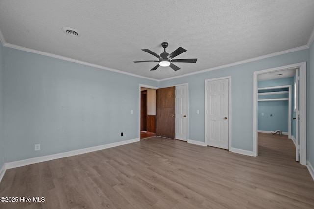 9952 US Highway 17 S, Vanceboro, NC 28586 - unfurnished bedroom with crown molding, a textured ceiling, baseboards, wood finished floors, and visible vents