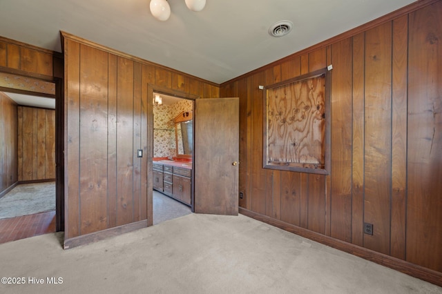 9952 US Highway 17 S, Vanceboro, NC 28586 - unfurnished bedroom with carpet flooring, baseboards, wood walls, and visible vents