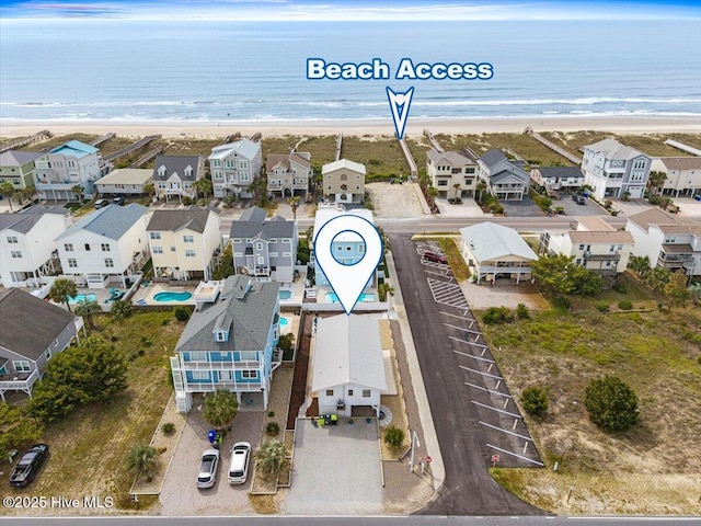 bird's eye view featuring a water view, a residential view, and a view of the beach