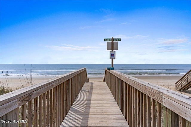 view of community with a beach view and a water view