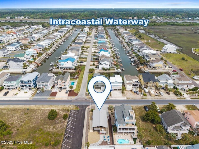 birds eye view of property with a water view and a residential view
