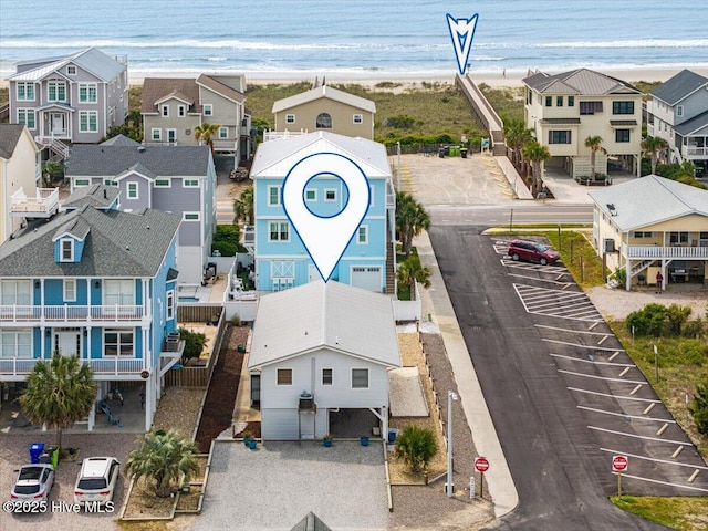 aerial view featuring a beach view, a residential view, and a water view