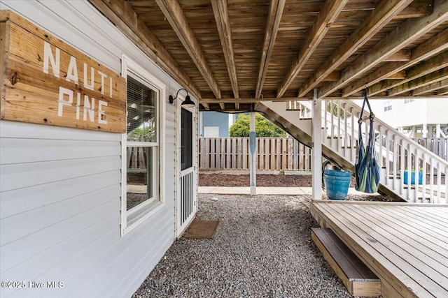 view of patio with stairway and fence