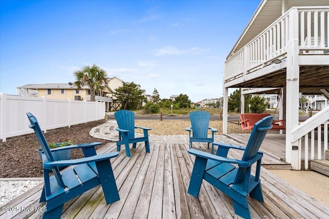 wooden terrace featuring fence