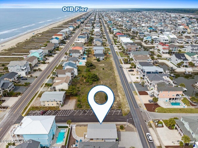 aerial view with a residential view, a beach view, and a water view
