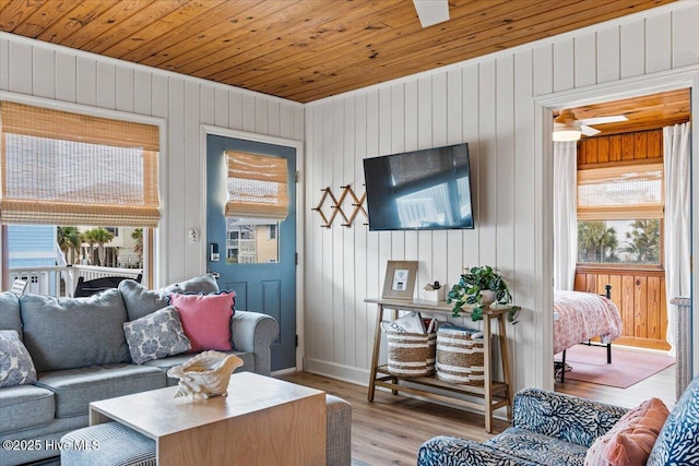 living area with wooden ceiling, light wood-type flooring, and a wealth of natural light