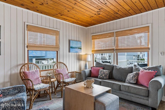 living area featuring wooden ceiling, plenty of natural light, and wood finished floors
