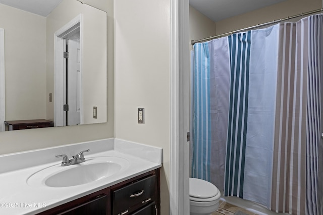 bathroom featuring toilet, a shower with curtain, and vanity