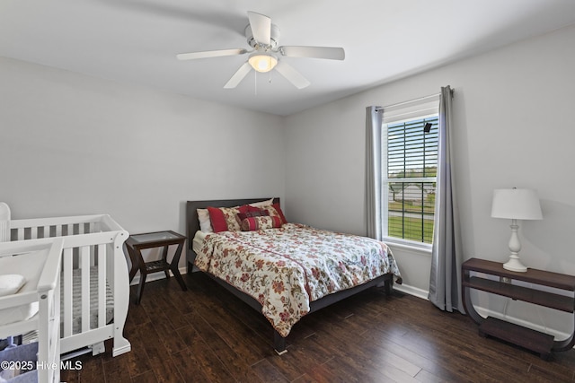 bedroom with baseboards, ceiling fan, and wood-type flooring