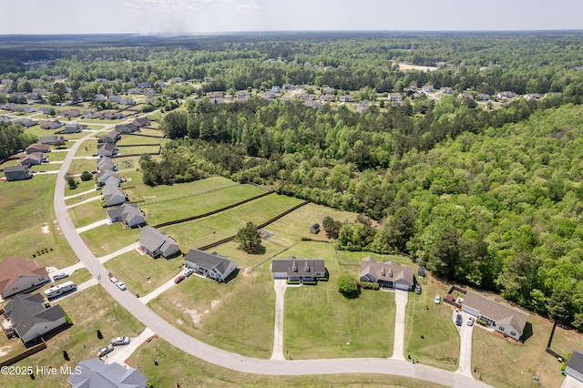 birds eye view of property featuring a wooded view
