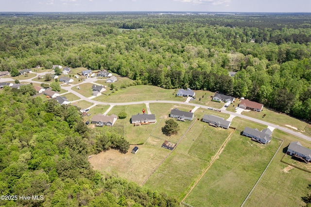 birds eye view of property with a wooded view