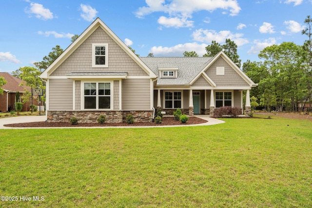 craftsman house featuring a front yard, a porch, and stone siding