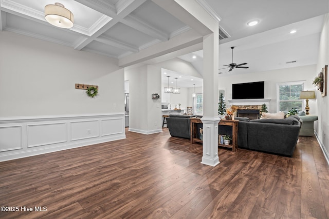 living room featuring a fireplace, beamed ceiling, ceiling fan with notable chandelier, dark wood-style floors, and recessed lighting