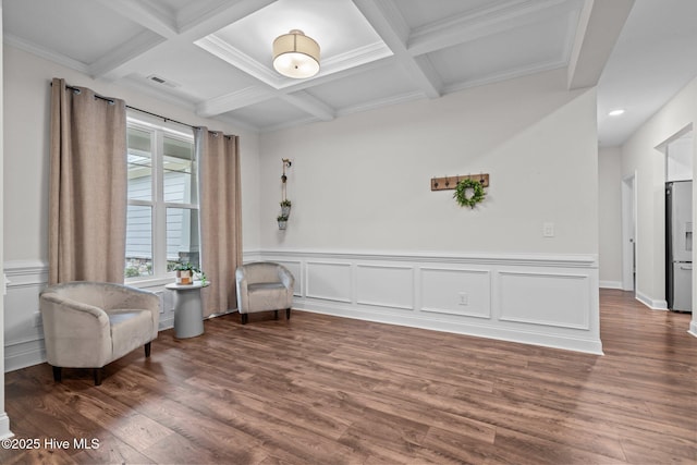 sitting room with coffered ceiling, wood finished floors, and beamed ceiling
