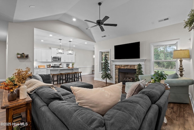 living room featuring vaulted ceiling, recessed lighting, dark wood-style floors, and visible vents