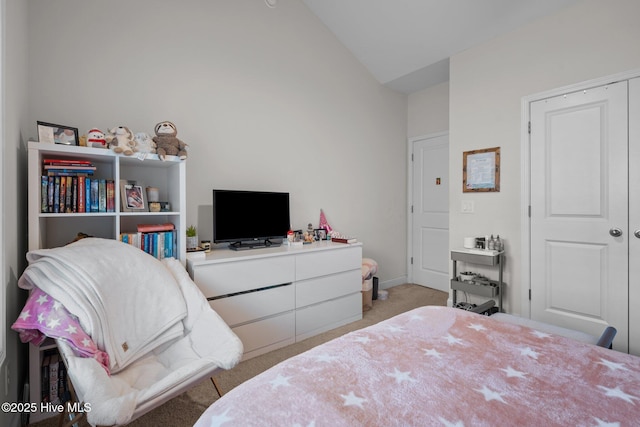 carpeted bedroom featuring baseboards and lofted ceiling