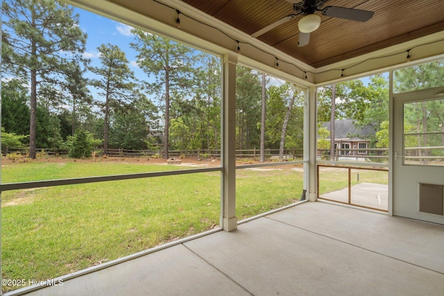 unfurnished sunroom featuring a ceiling fan