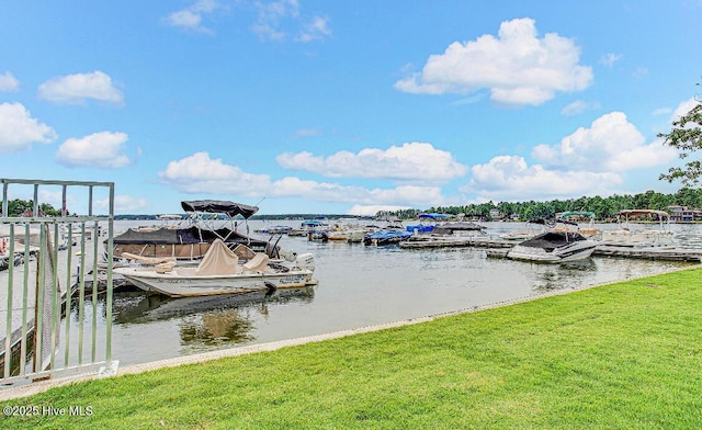 dock area featuring a lawn and a water view