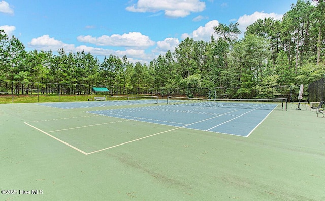 view of tennis court featuring fence and community basketball court