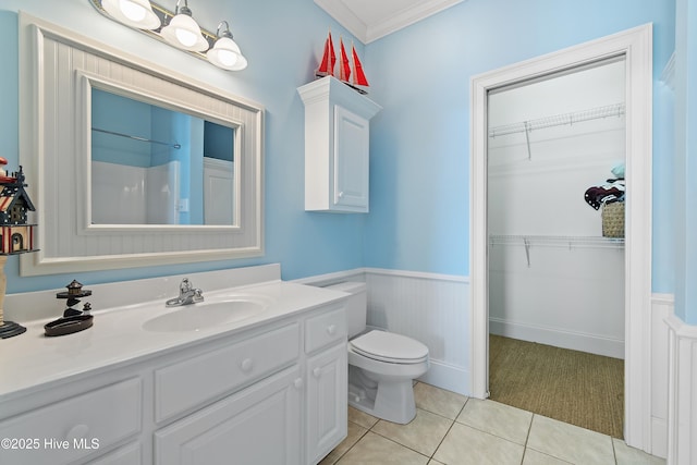 107 Waterway Crossing Ct, Little River, SC 29566 - bathroom featuring wainscoting, tile patterned floors, toilet, a walk in closet, and vanity