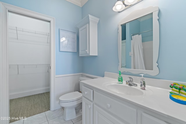 107 Waterway Crossing Ct, Little River, SC 29566 - bathroom featuring toilet, vanity, wainscoting, tile patterned flooring, and a walk in closet