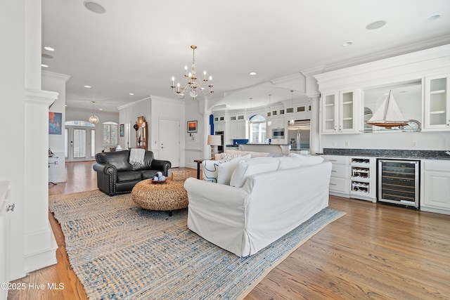 107 Waterway Crossing Ct, Little River, SC 29566 - living area featuring wine cooler, a chandelier, ornamental molding, ornate columns, and recessed lighting