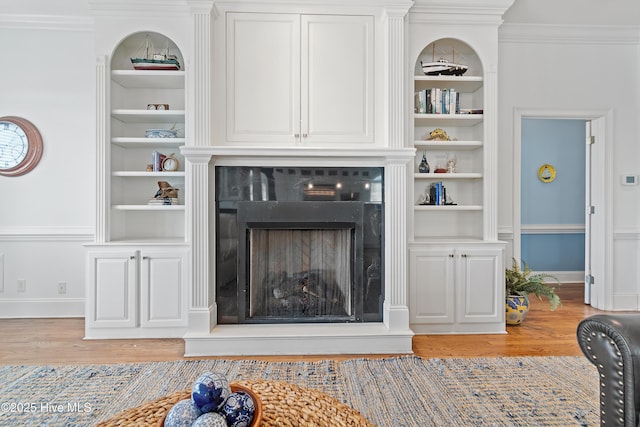 107 Waterway Crossing Ct, Little River, SC 29566 - living area featuring built in shelves, light wood-type flooring, a fireplace with raised hearth, baseboards, and ornamental molding