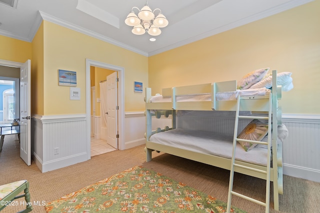 107 Waterway Crossing Ct, Little River, SC 29566 - carpeted bedroom with a chandelier, ornamental molding, a wainscoted wall, and ensuite bathroom