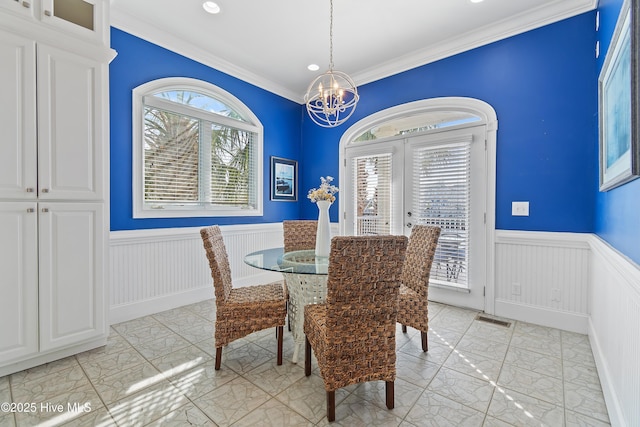 107 Waterway Crossing Ct, Little River, SC 29566 - dining space with wainscoting, a chandelier, crown molding, light marble finish flooring, and recessed lighting