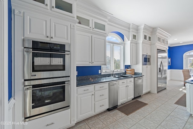 107 Waterway Crossing Ct, Little River, SC 29566 - kitchen featuring built in appliances, a sink, dark countertops, crown molding, and white cabinets