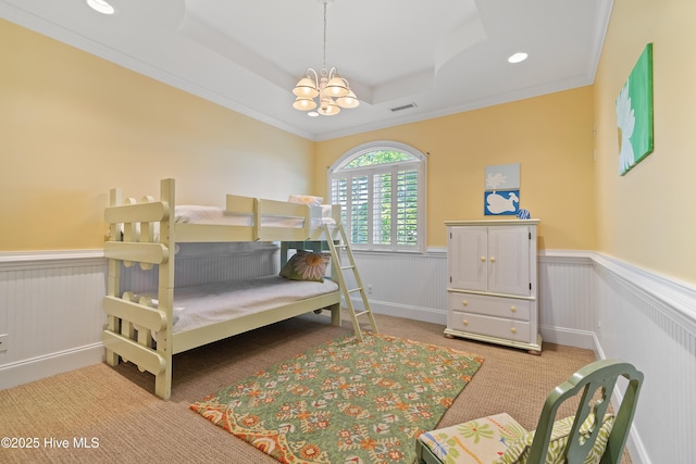 107 Waterway Crossing Ct, Little River, SC 29566 - bedroom with a tray ceiling, a wainscoted wall, light colored carpet, a chandelier, and ornamental molding
