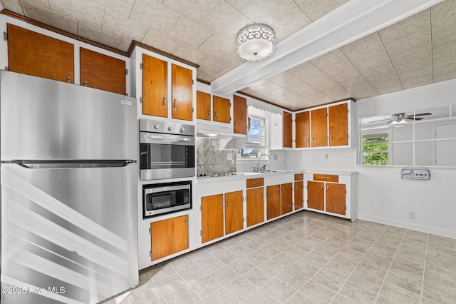 480 Croatan St, Belhaven, NC 27810 - kitchen featuring light countertops, brown cabinets, appliances with stainless steel finishes, and a wealth of natural light