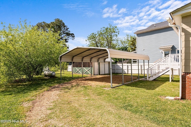480 Croatan St, Belhaven, NC 27810 - view of yard featuring driveway, a detached carport, fence, a storage unit, and stairs