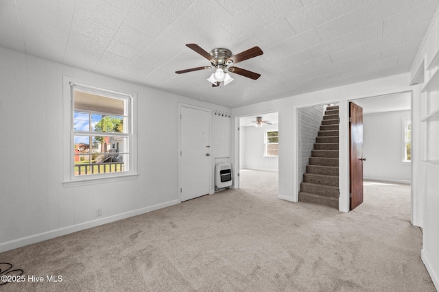 480 Croatan St, Belhaven, NC 27810 - unfurnished living room featuring carpet floors, heating unit, ceiling fan, and stairs