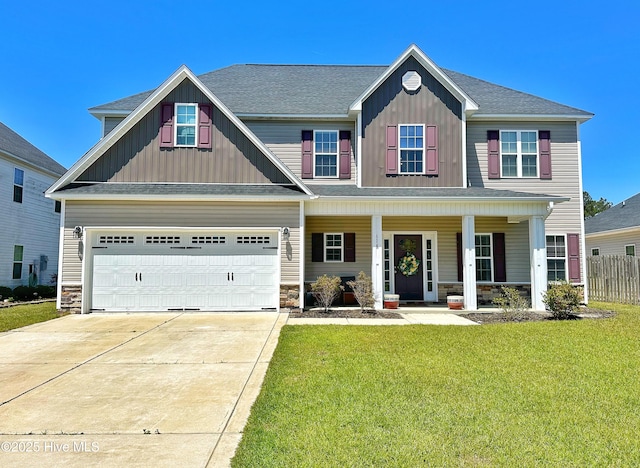 craftsman-style house featuring driveway, board and batten siding, stone siding, covered porch, and a front lawn