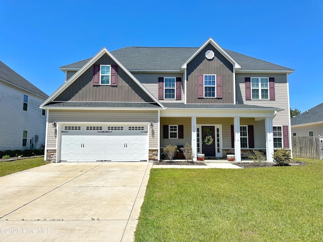 craftsman inspired home featuring board and batten siding, covered porch, stone siding, a front lawn, and concrete driveway