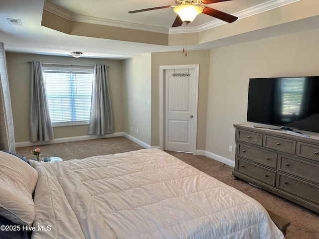 carpeted bedroom featuring visible vents, a tray ceiling, ornamental molding, and baseboards