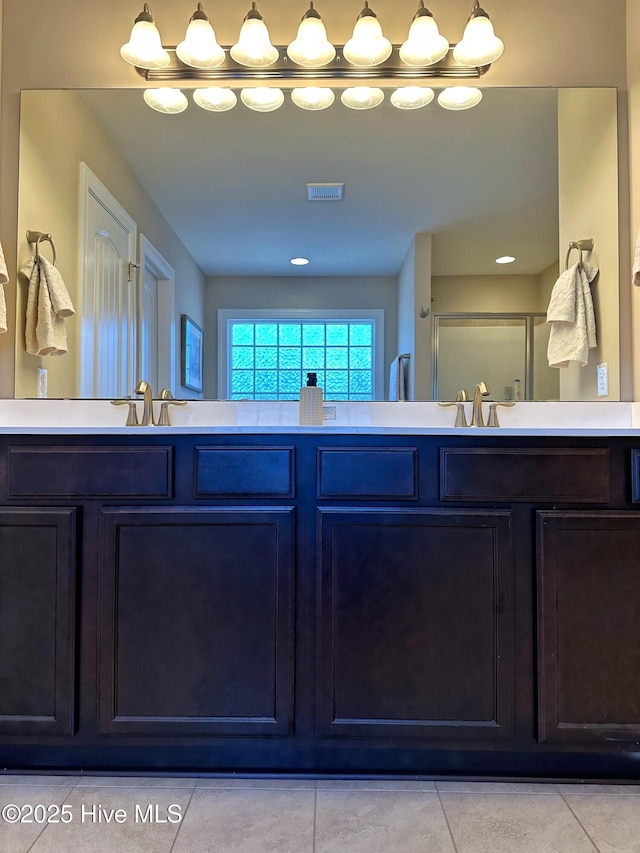 full bath with tile patterned floors, a sink, visible vents, and double vanity