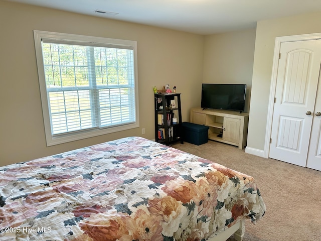 bedroom with carpet, visible vents, and baseboards